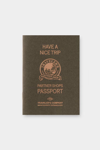 Passport-sized stamp refill insert, dark brown cover with Partner Shops Passport emblem