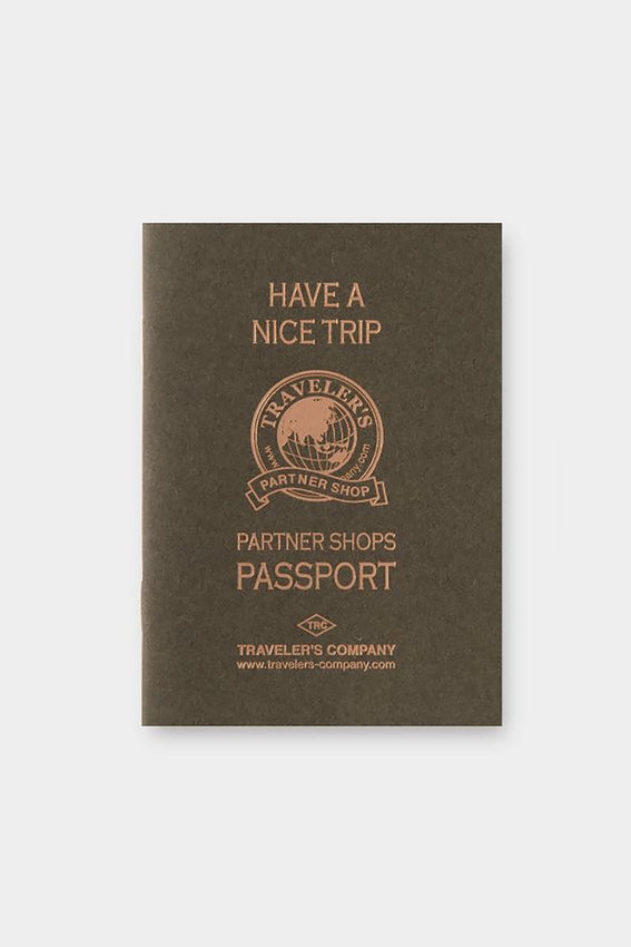 Passport-sized stamp refill insert, dark brown cover with Partner Shops Passport emblem