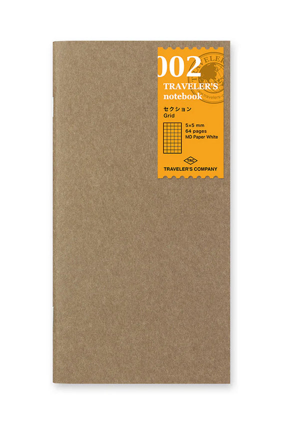 Kraft grid notebook with a 002 label and square-grid badge on the cover