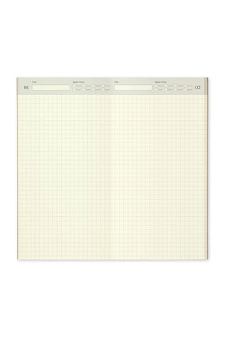 Closed Traveler's notebook spread with light grid paper and page markers