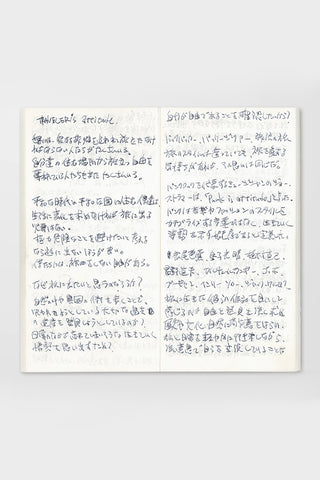 Lightweight paper notebook open with handwritten notes across two blank pages.