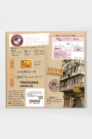 Opened kraft paper notebook with printed travel map and stamp-style inserts