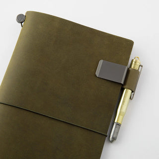 Traveler's notebook pen holder with olive-green cover and pen secured on notebook