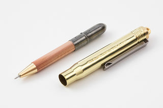 Wooden-shaft ballpoint pen with brass barrel and open replacement tip sleeve