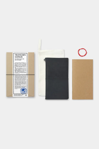 Black Traveler's notebook with cover band, plus white pouch and beige paper