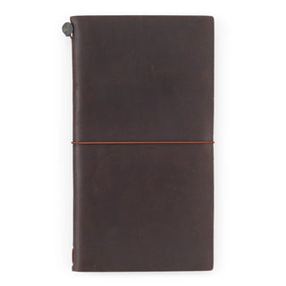 Brown leather traveler's notebook with elastic strap and corner button clasp.