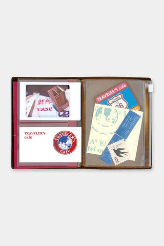 Passport zipper case opened, showing card sleeves and printed inserts.