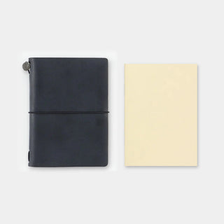 Traveler's notebook monthly planner covers, navy and cream, closed with elastic band