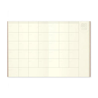 Traveler's notebook monthly planner spread with grid lines and circular top right mark
