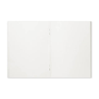 Opened passport-size sketch paper notebook showing two blank pages