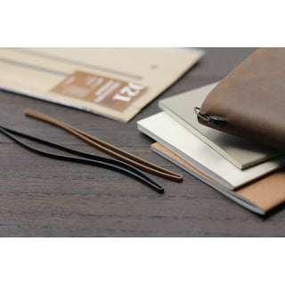 Brown leather-look notebook cover with two elastic binding bands and stacked refills