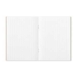 Open passport-size notebook showing two dot-grid pages