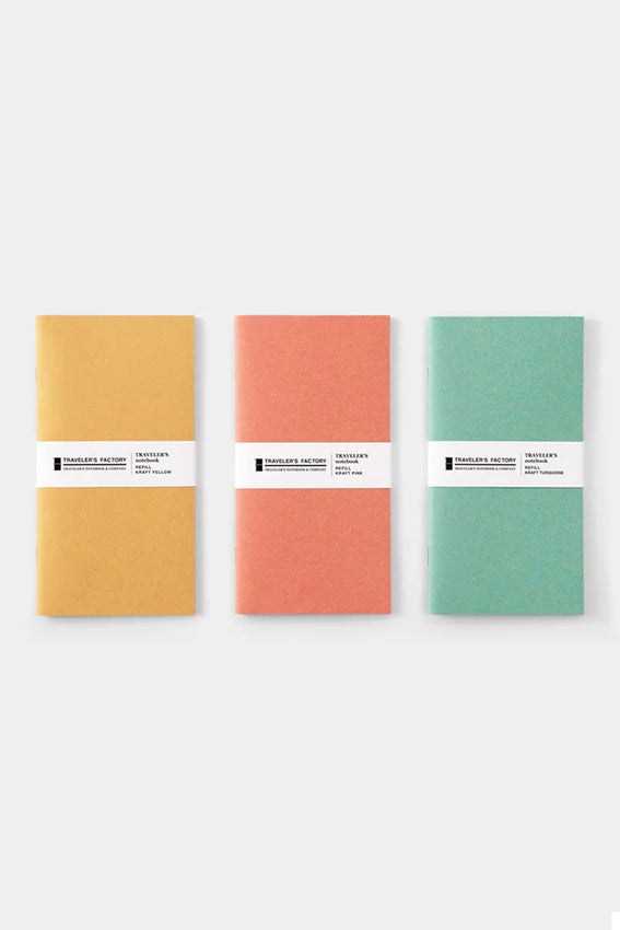Three kraft notebook refills in yellow, pink, and turquoise with band labels