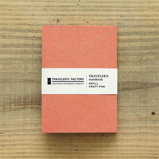 Pink kraft passport-size notebook with Traveler's Factory label