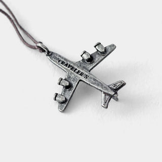 Close-up of pewter airplane charm with braided cord and hanging loop.