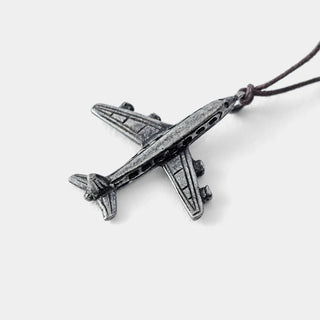 Pewter airplane charm on cord, detailed side view.