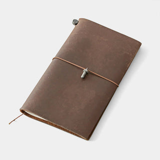 Pewter bolt charm tied to brown notebook cover with cord