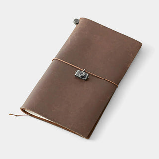 Pewter camera charm attached to brown leather notebook with hanging cord