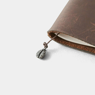 Pewter coffee bean charm hanging from black cord