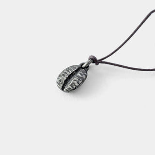Close-up pewter coffee bean charm with black cord loop