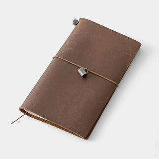 Brown leather notebook cover with stitched binding and pewter mug charm clip.