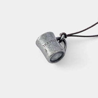 Pewter mug charm close-up with dark cord loop and raised embossed text.