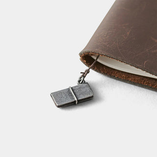 Pewter mini notebook charm attached to brown leather journal with cord