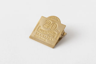 Gold 20th anniversary Traveler's notebook charm-shaped metal tag