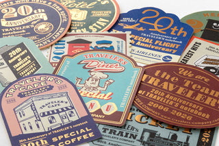 Assorted 20th anniversary sticker sheets with travel-themed graphics and lettering