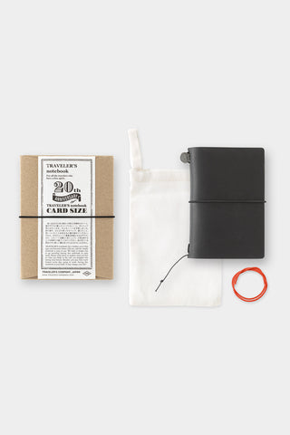 Card-size notebook set with black cover, white pouch, and red cord, plus info card.