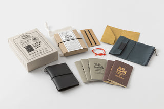 Black and brown card-size notebook anniversary set, pouches, refills, and pen loops