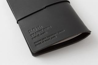 Close-up of black notebook cover debossed text and logo