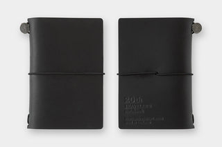 Two black card-size notebooks, open view with inner text and elastic strap