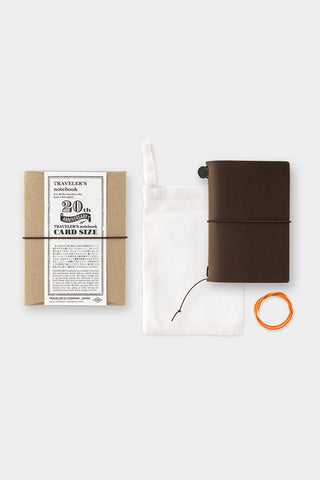 20th anniversary card-size notebook set with brown cover, pouch, and small accessories