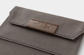 Close-up of brown card-size notebook front flap with embossed leather logo patch