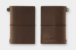 Brown card-size notebook cover with elastic band and two round button closures