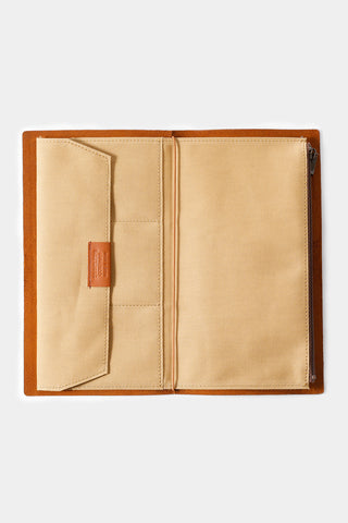 Beige cotton zipper case open, showing stitched interior pocket and label tab