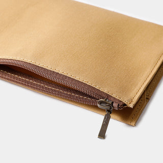 Beige cotton zipper case close-up of zipper track and fabric fold edge