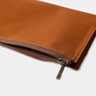 Close-up of brown cotton zipper case edge with zipper pull and stitching
