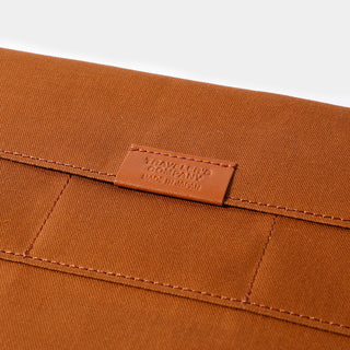 Brown cotton zipper case label on interior panel with stitched seam