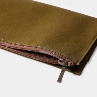 Olive cotton zipper edge with pinkish-brown zipper tape and metal zipper pull