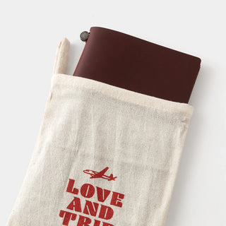 Cloth pouch with LOVE AND TRIP logo and burgundy leather journal cover