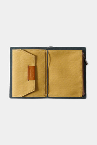 Beige passport-size cotton zipper case open, showing interior panel and card pocket.