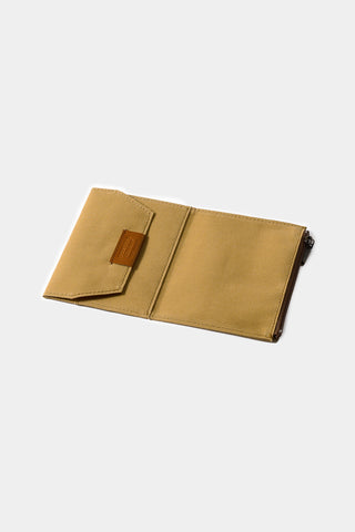 Beige passport-size cotton zipper case open, inner card pocket visible, zipper edge.