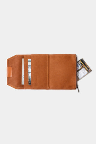 Brown cotton passport-size zipper case opened, shows document slots and interior panels