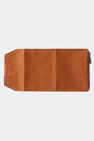 Brown cotton passport-size zipper case, side profile with metal zipper at top edge