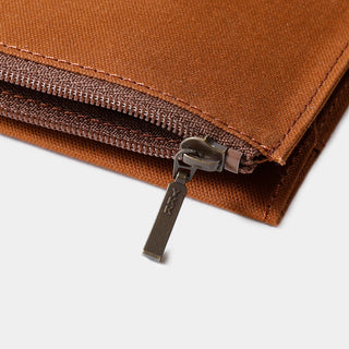 Brown cotton case zipper detail with metal slider and stitching along the edge