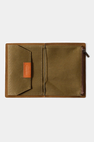 Olive cotton passport-size zipper case open, interior panels with orange brand tag and zipper