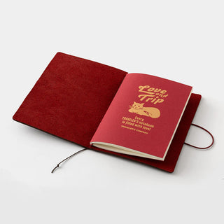 Passport-size notebook open with red cover and booklet labeled “Love and Trip”