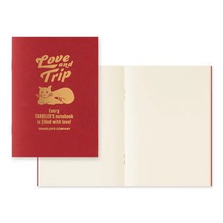 Red “Love and Trip” cover with open cream pages in passport-size notebook format